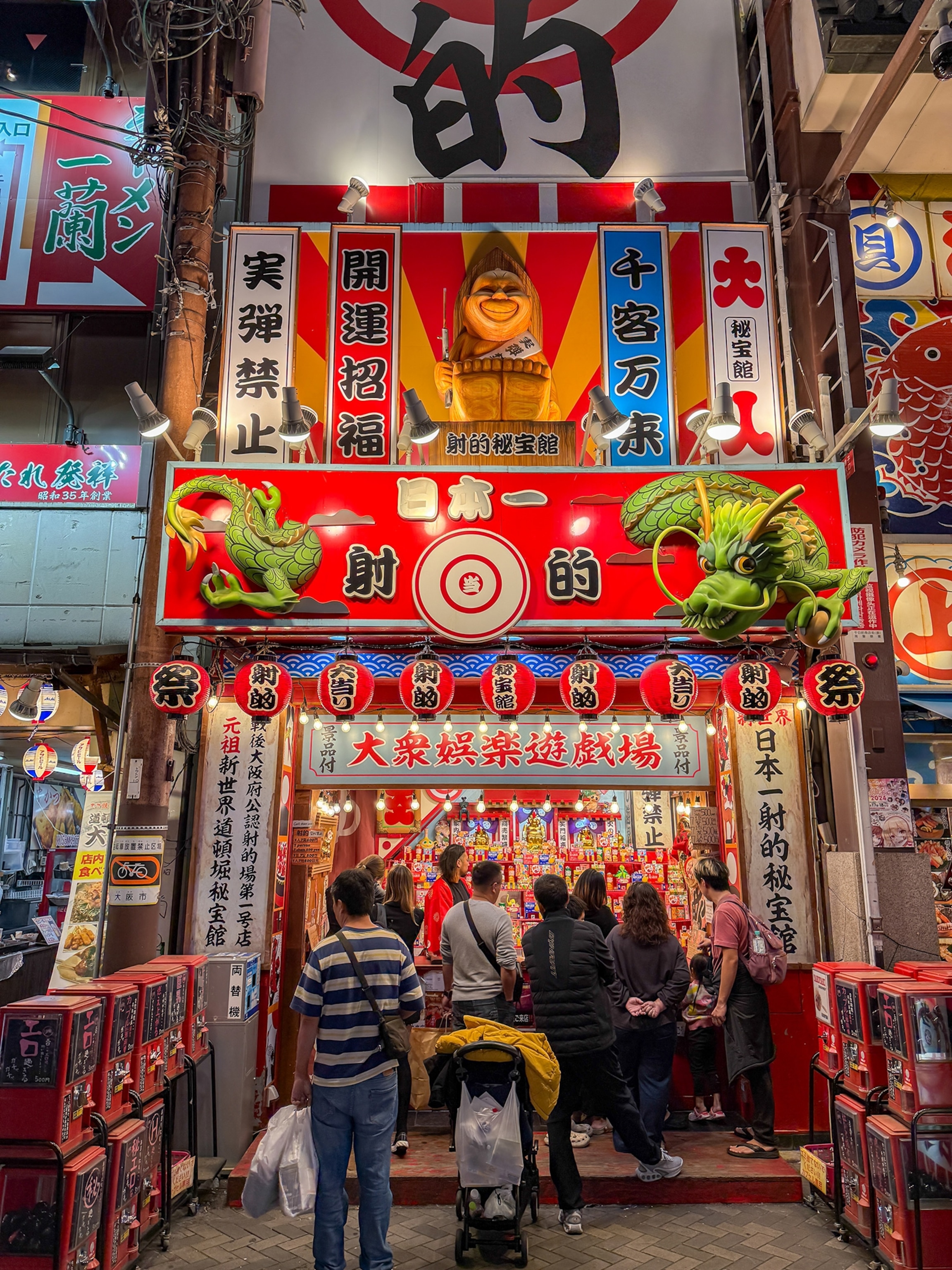 A colorful stall with people lined up.