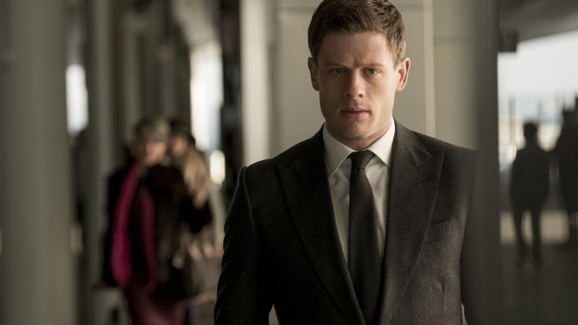 A man in a suit stares down in McMafia.