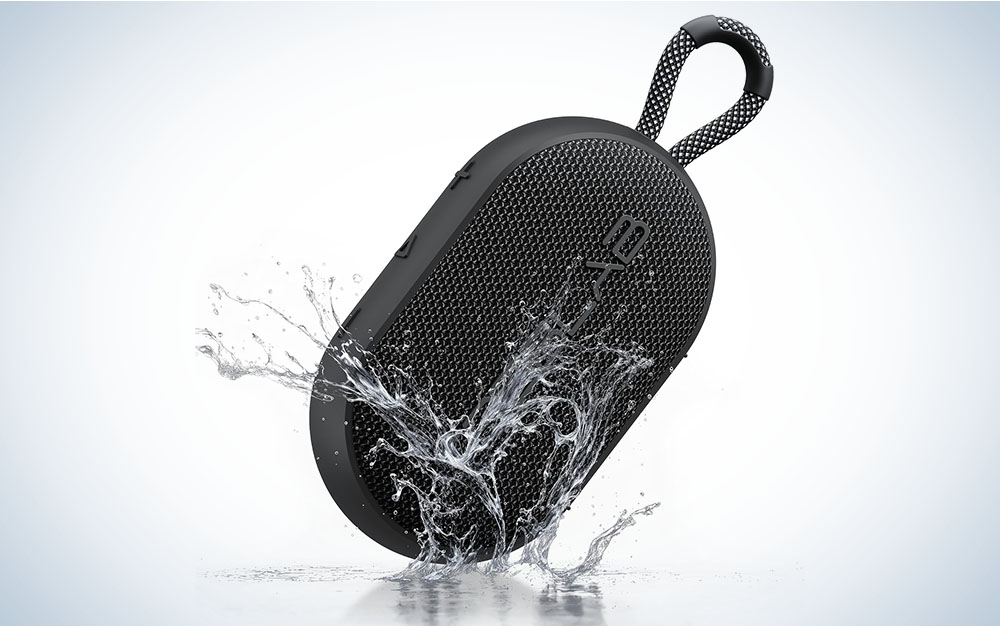 Black TREBLAB HD-Go speaker splashing into water on a grey gradient