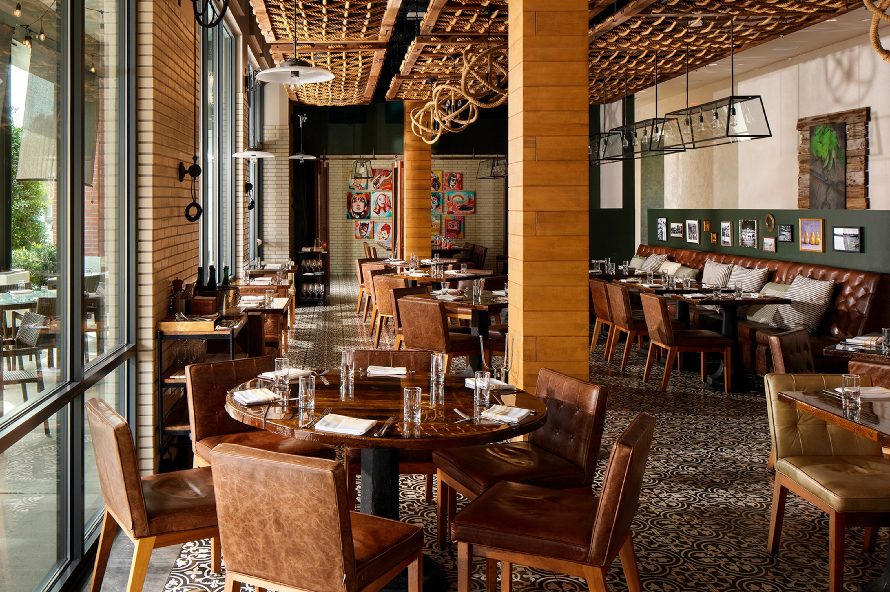 The stylish interior of a slightly sailing-themed restaurant with tiled floor and sailing rope details on the ceiling.
