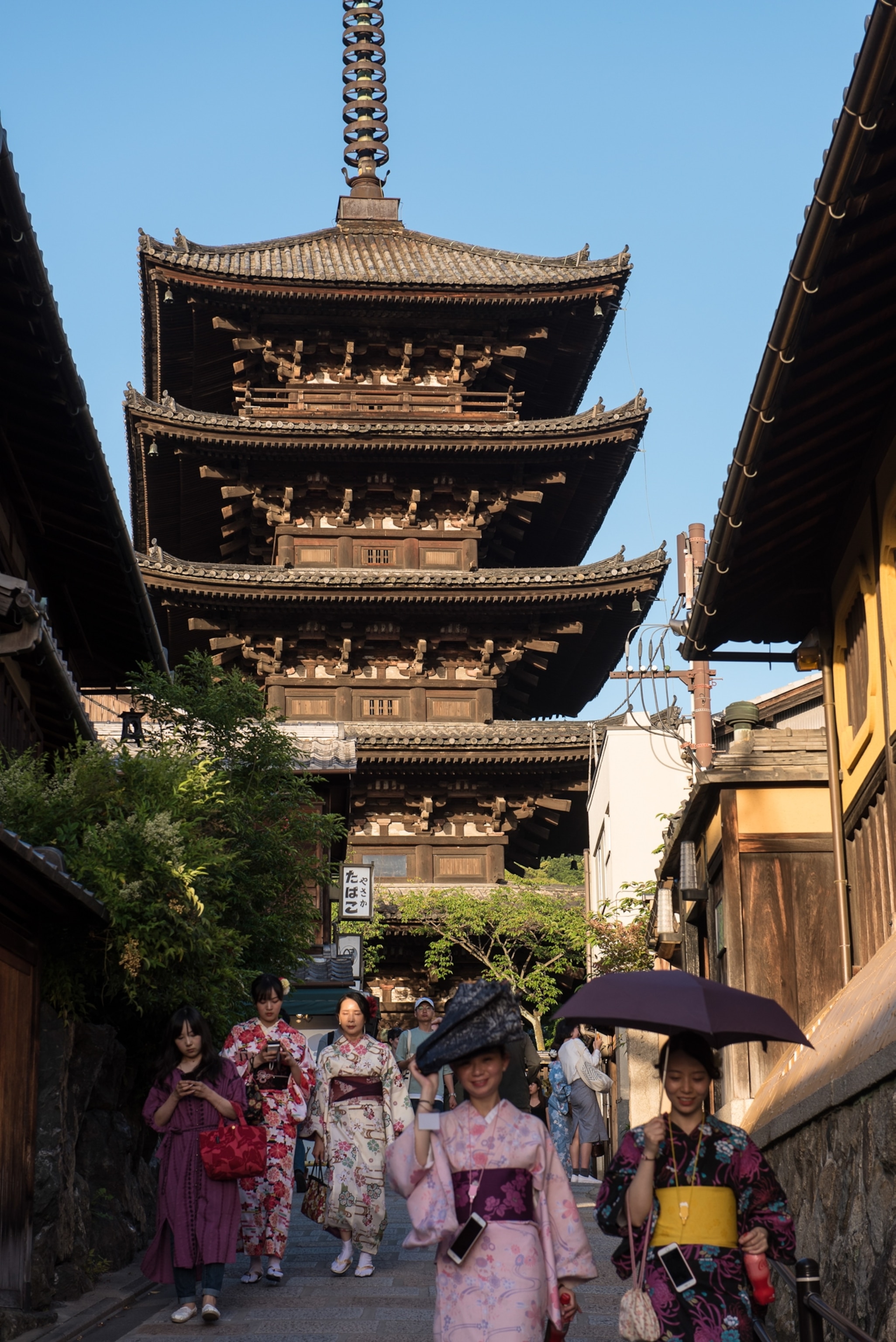 A tiered building with women walking.