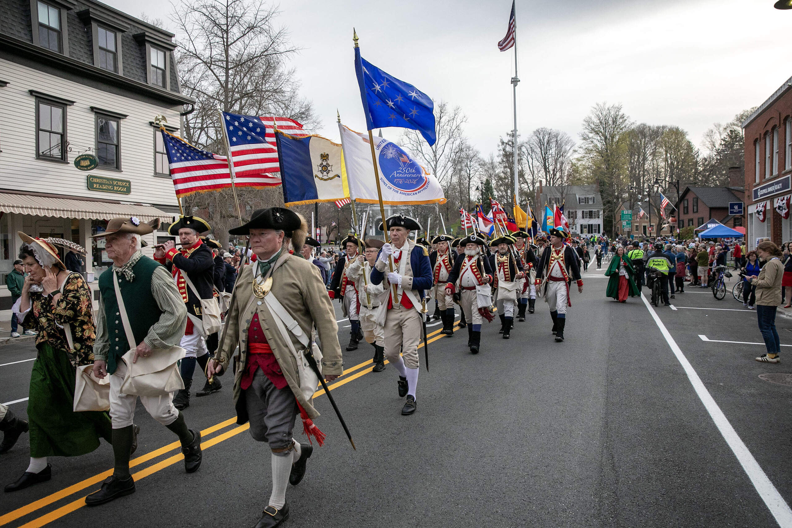 Members of the Sons of the American Revolution march along Main Street in Concord. (Robin Lubbock/WBUR)