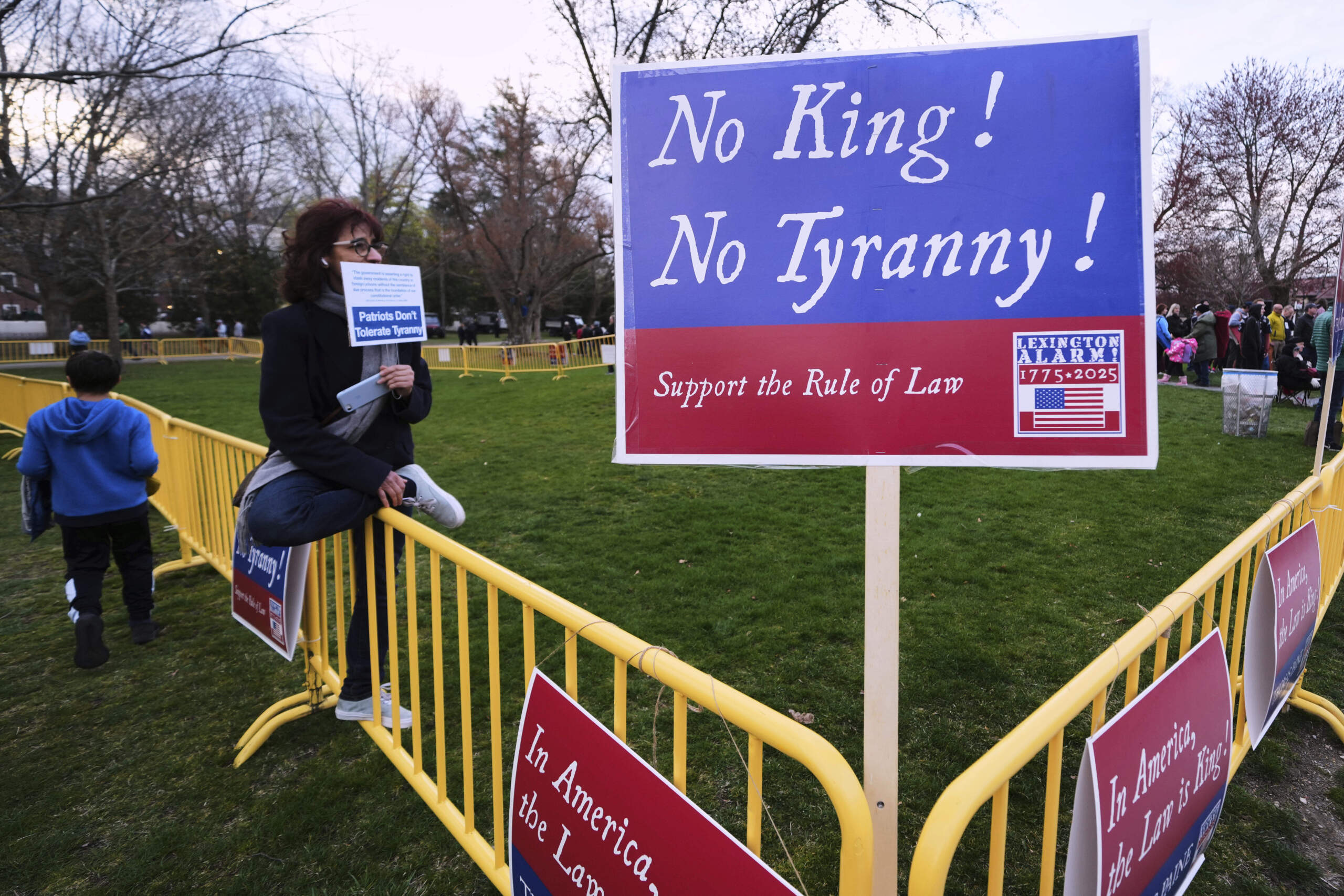 A lone protestor sits in the "Free Speech Zone" during the reenactment. (Charles Krupa/AP)
