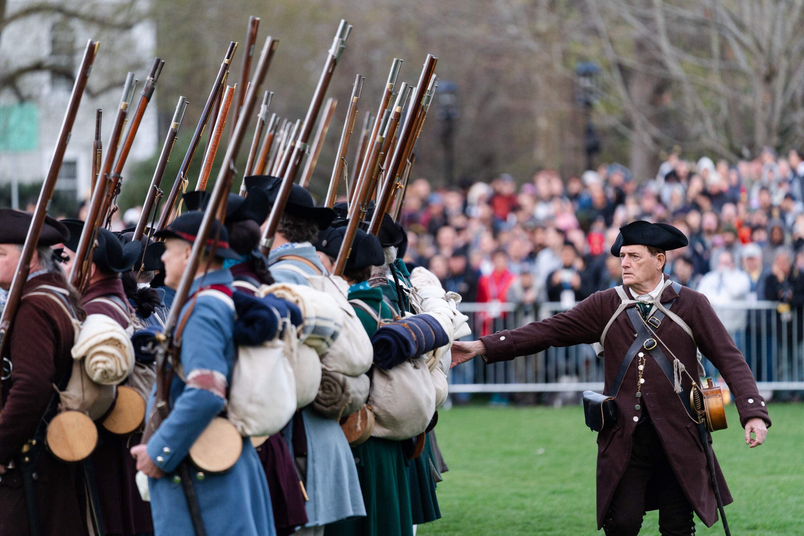 Reenactors depicting members of the Lexington Minute Men have their weapons checked after the 250th reenactment of the Battle of Lexington. (Sophie Park/Getty Images)