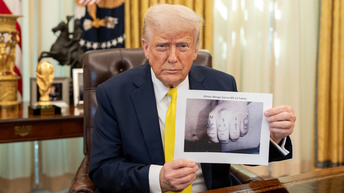Donald Trump holds up alleged MS-13 tattoo image