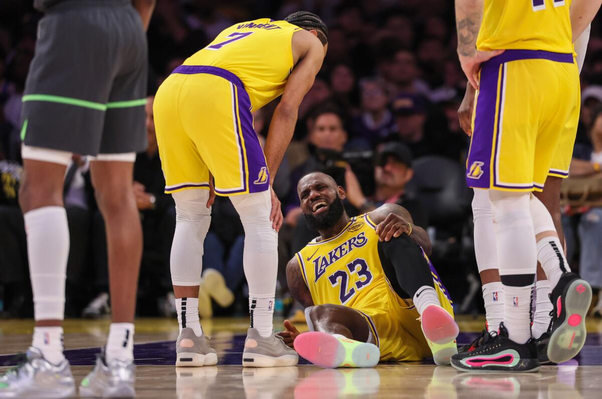 LeBron James cringes in pain after injuring his leg in the second half.