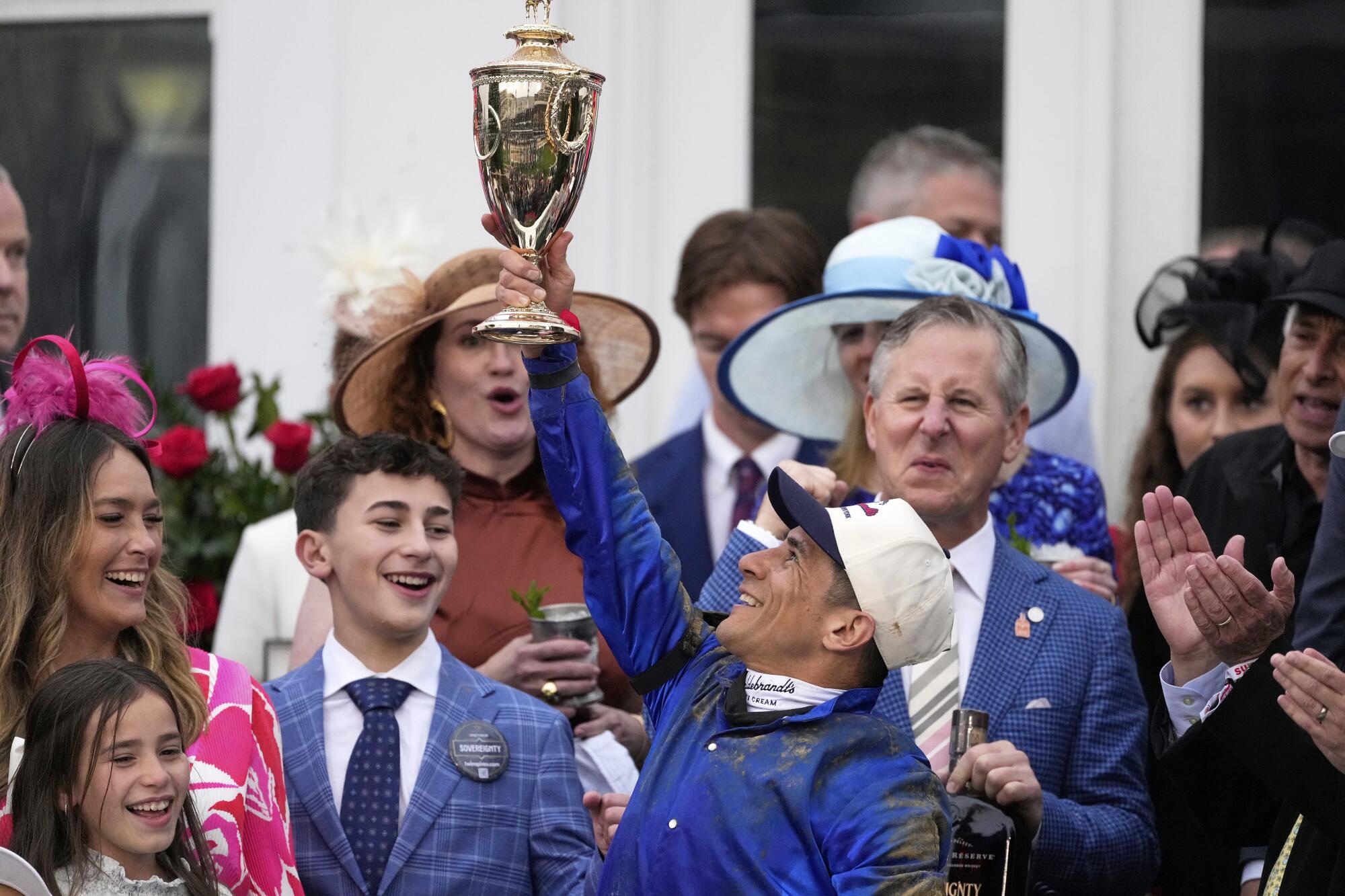 Jockey Junior Alvarado celebrates after winning the Kentucky Derby atop Sovereignty.