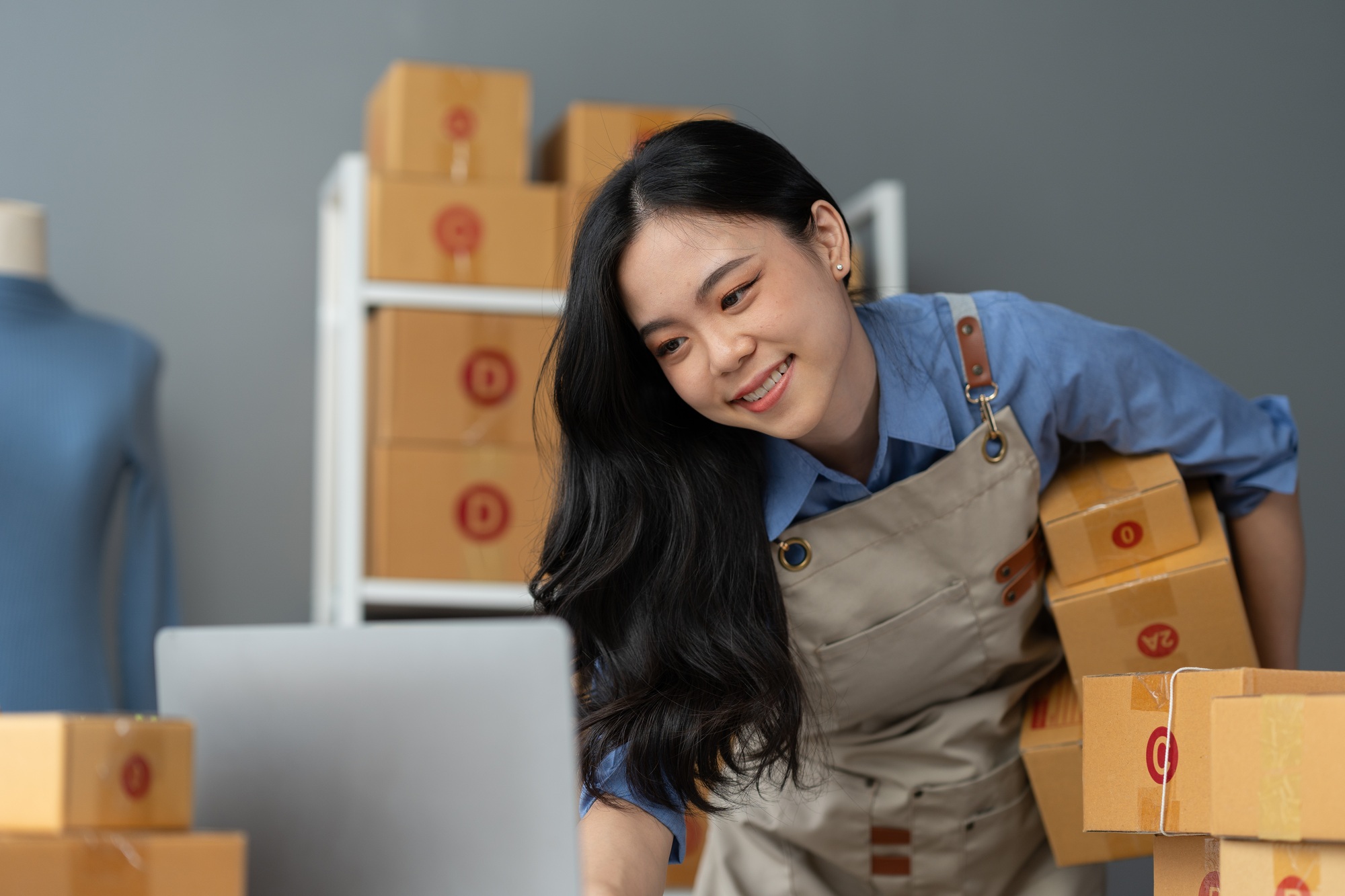 Start up small business entrepreneur SME or freelance asian woman using laptop with box, Young succe
