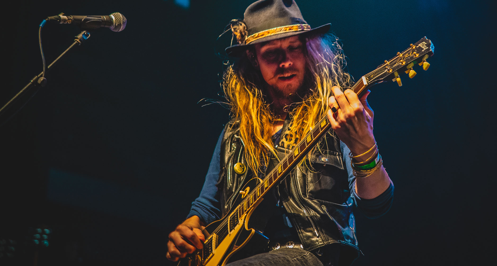 Dave Dalone of Swedish rockers H.E.A.T plays a Gibson Les Paul and wears a wide-brimmed hat and black leather waistcoat.