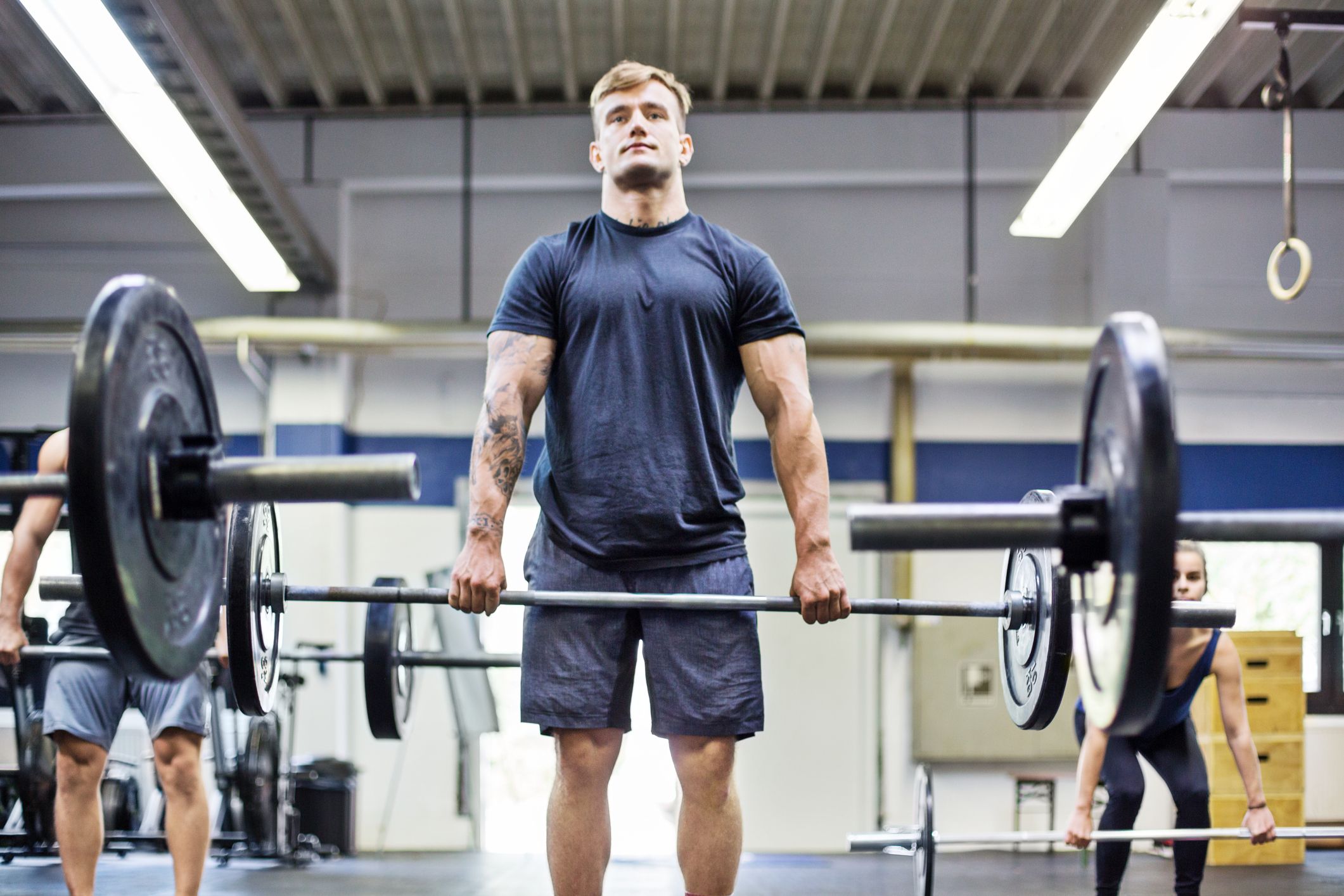 Confident man lifting dumbbell in health club