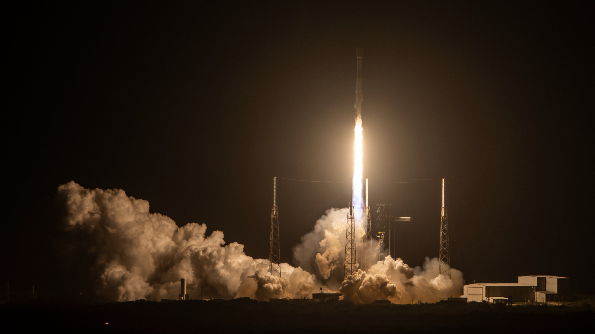 a rocket launches into a dark night sky