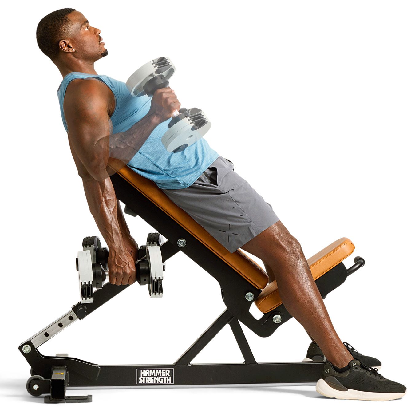 Individual performing a strength training exercise with dumbbells on an incline bench Individual performing a strength training exercise with dumbbells on an incline bench