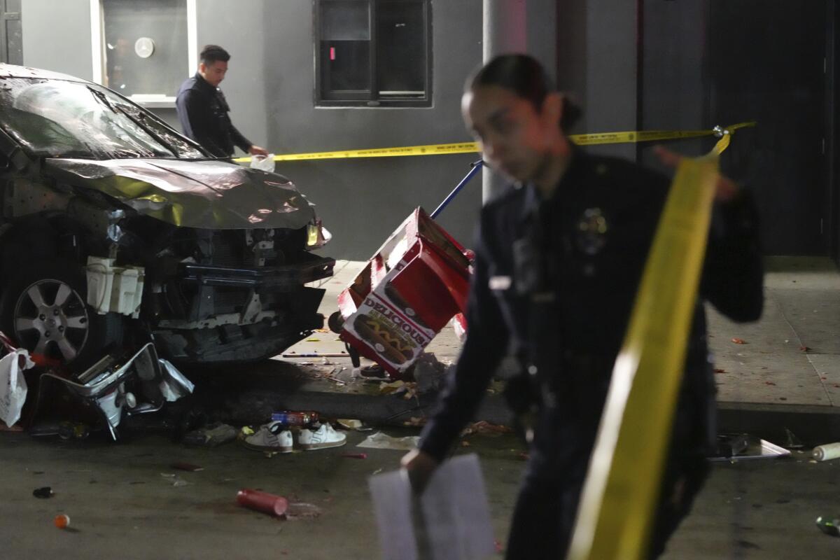 Law enforcement investigate the scene where a vehicle rammed into a crowd of people waiting to enter a nightclub.