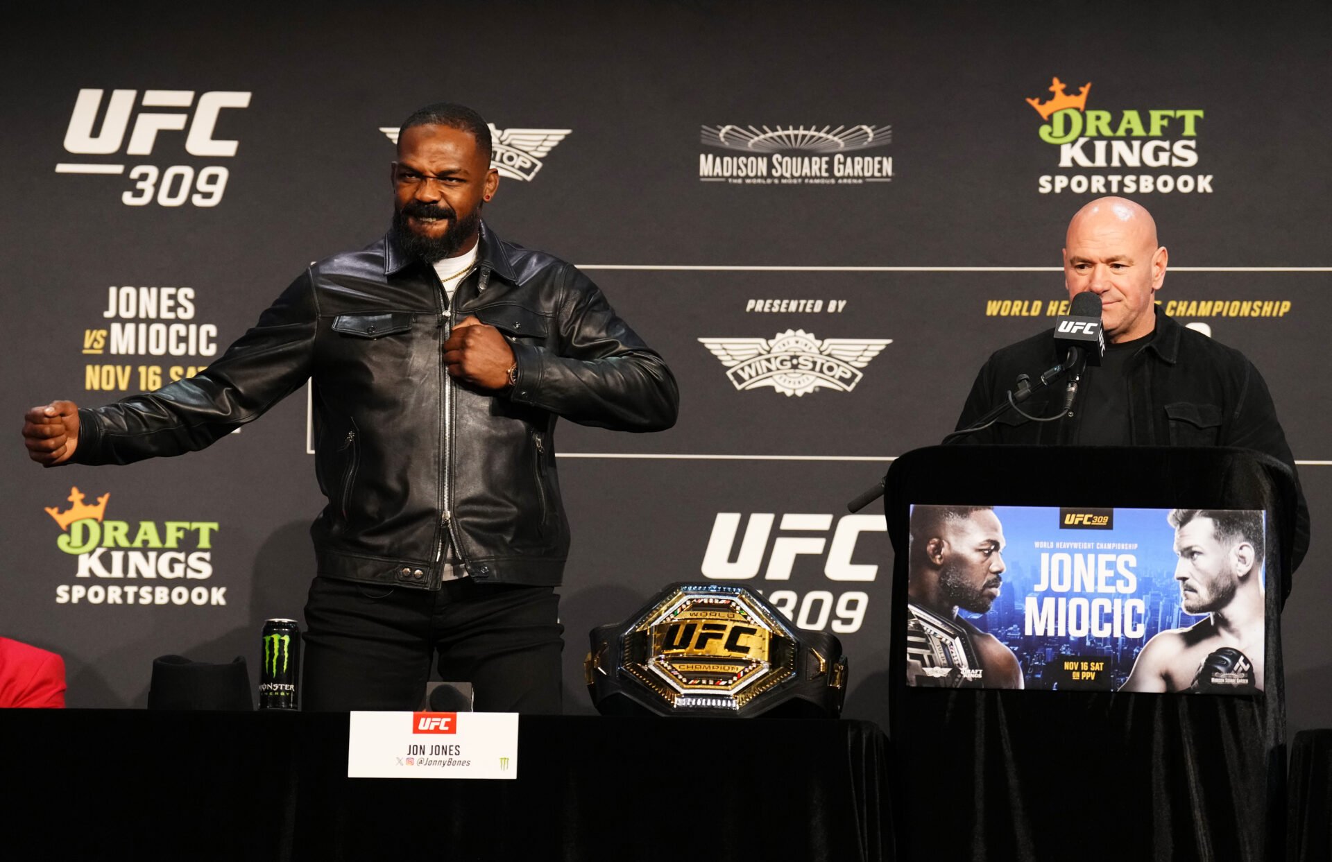Jon Jones acknowledges the crowd alongside UFC CEO Dana White at the UFC 309 press conference