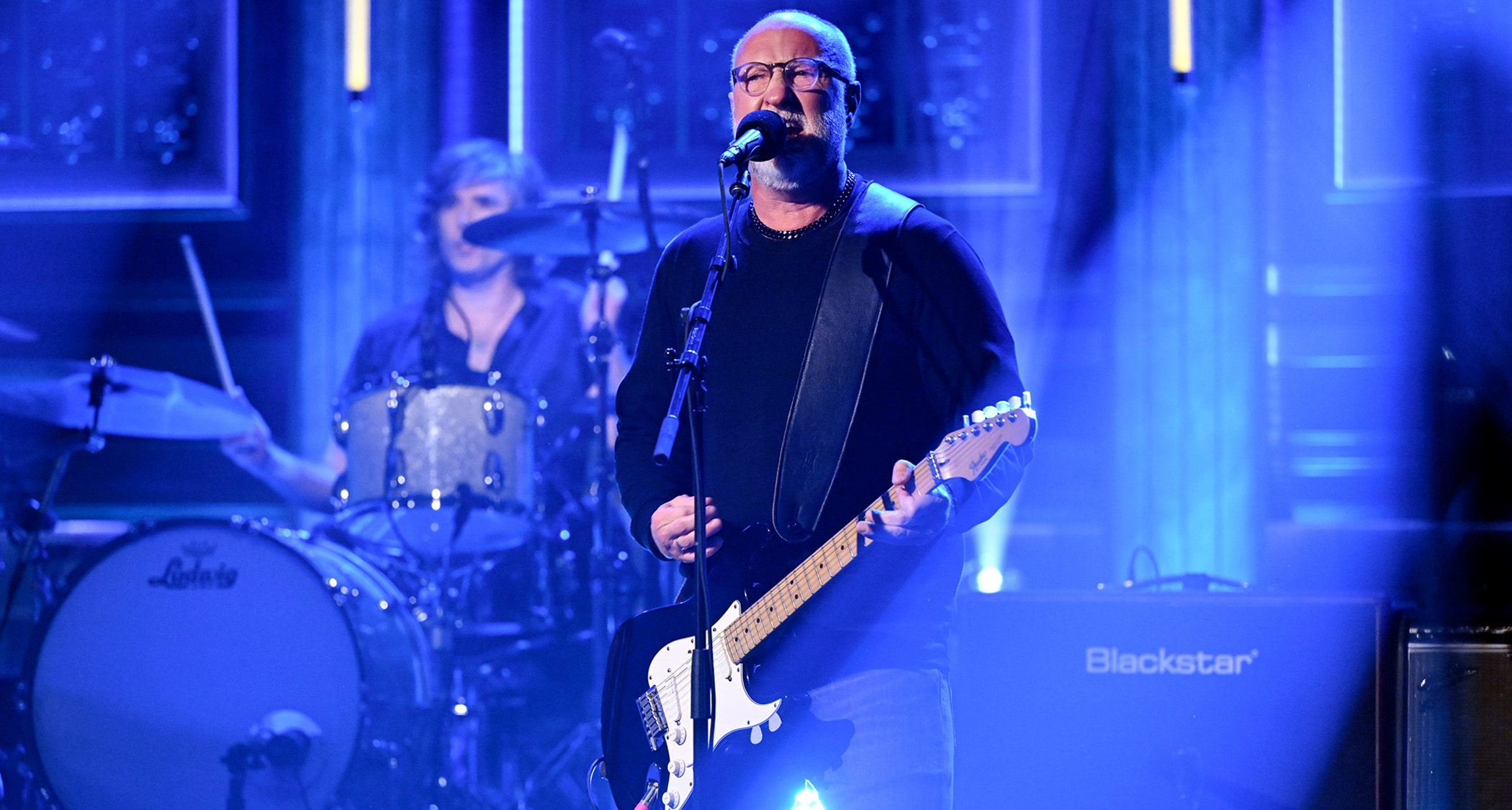Bob Mould plays The Tonight Show Starring Jimmy Fallon on a stage lit in blue