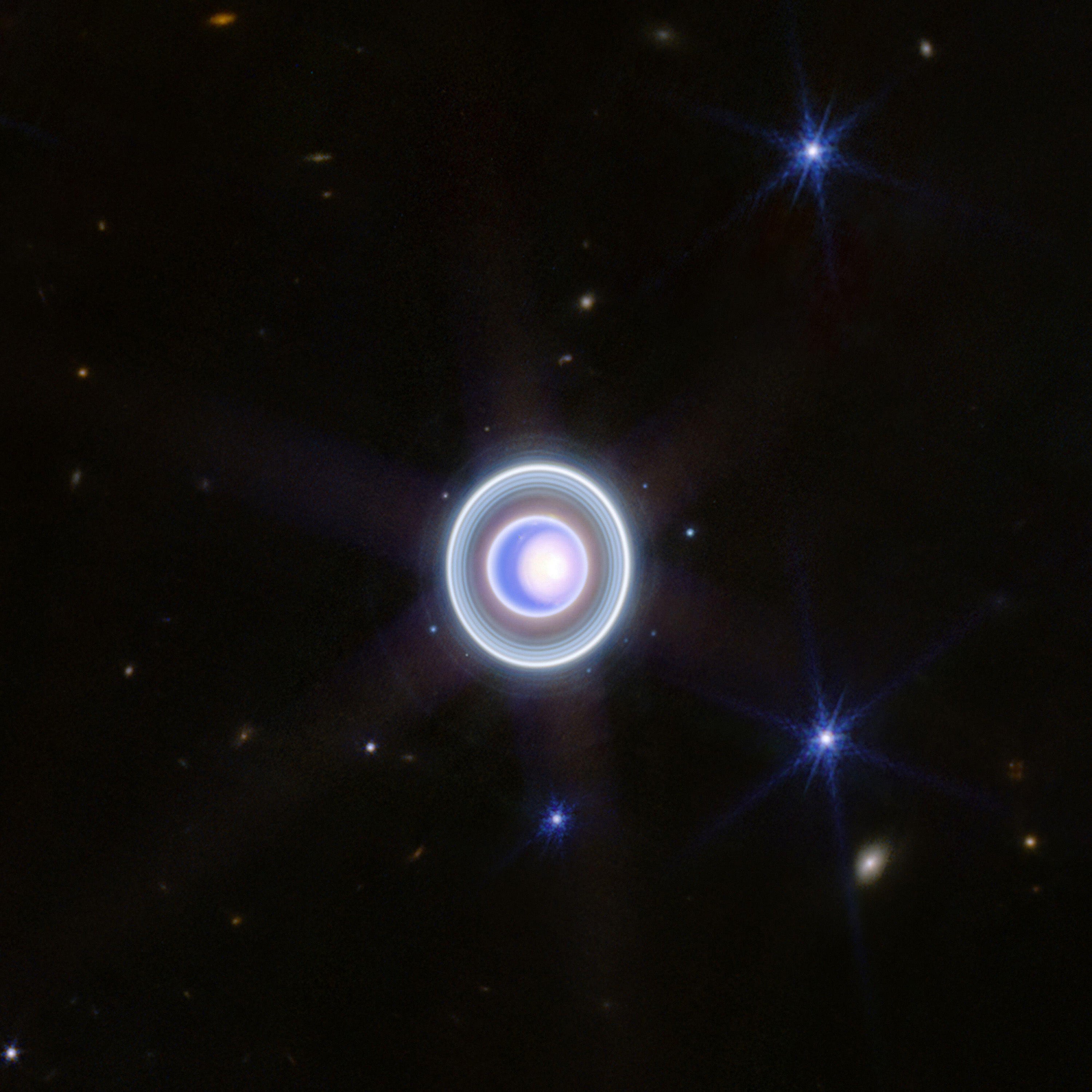Uranus with bright polar cap, rings, and moons
