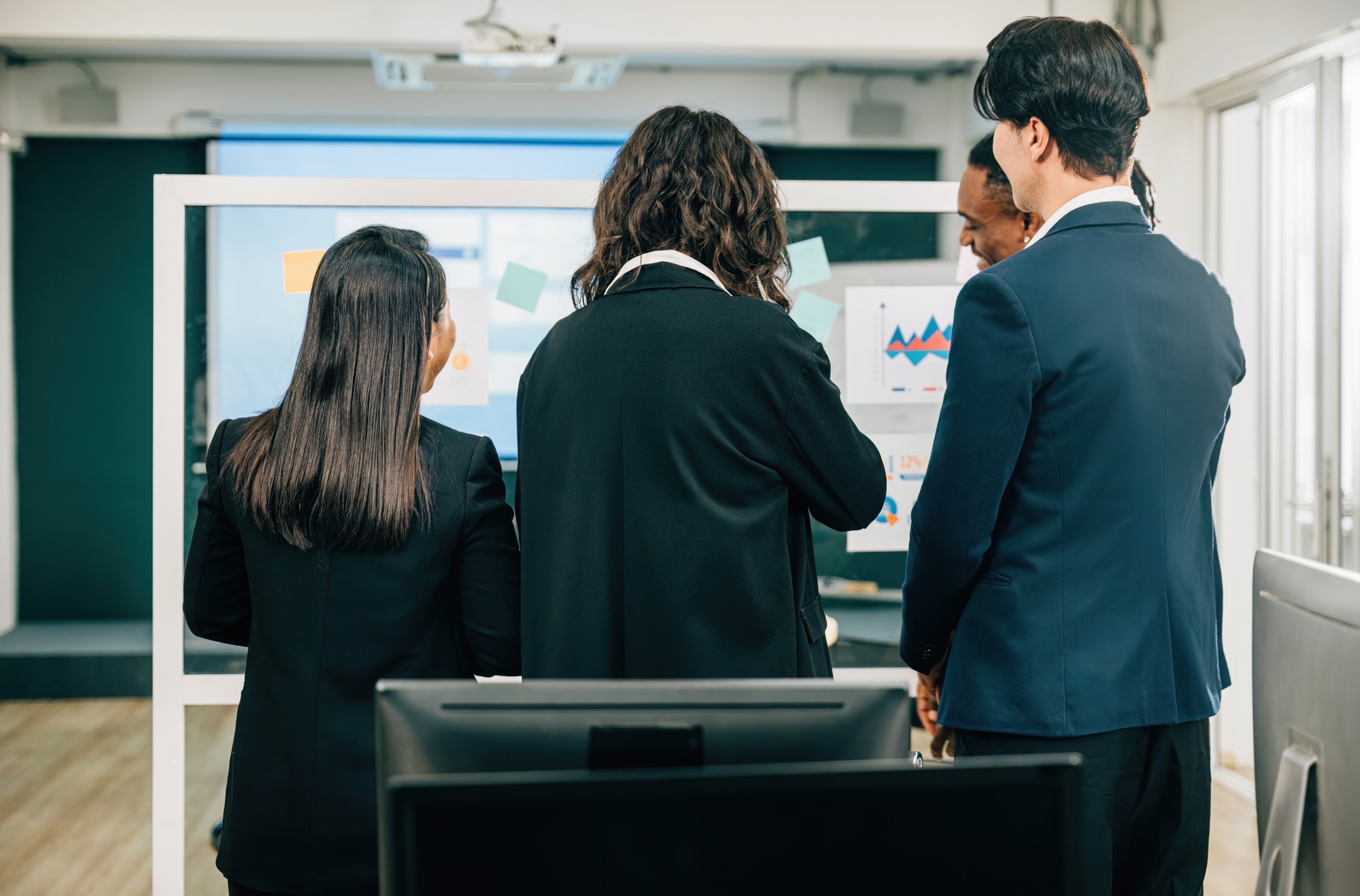 Conference room, employees collaborate in a back meeting, sharing diverse ideas and strategies for