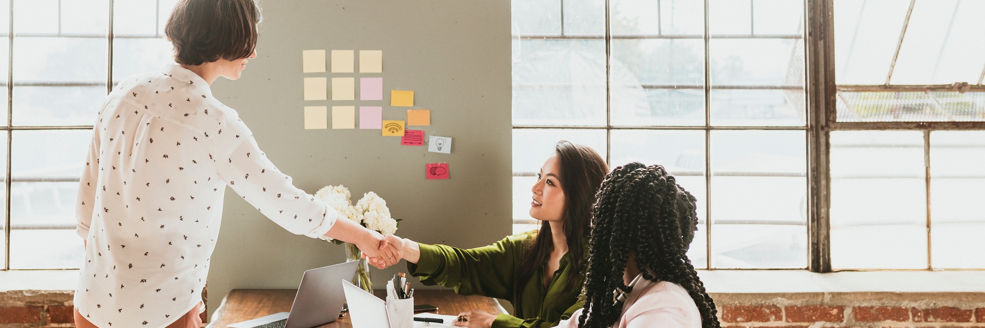 Happy businesswomen doing a handshake social template