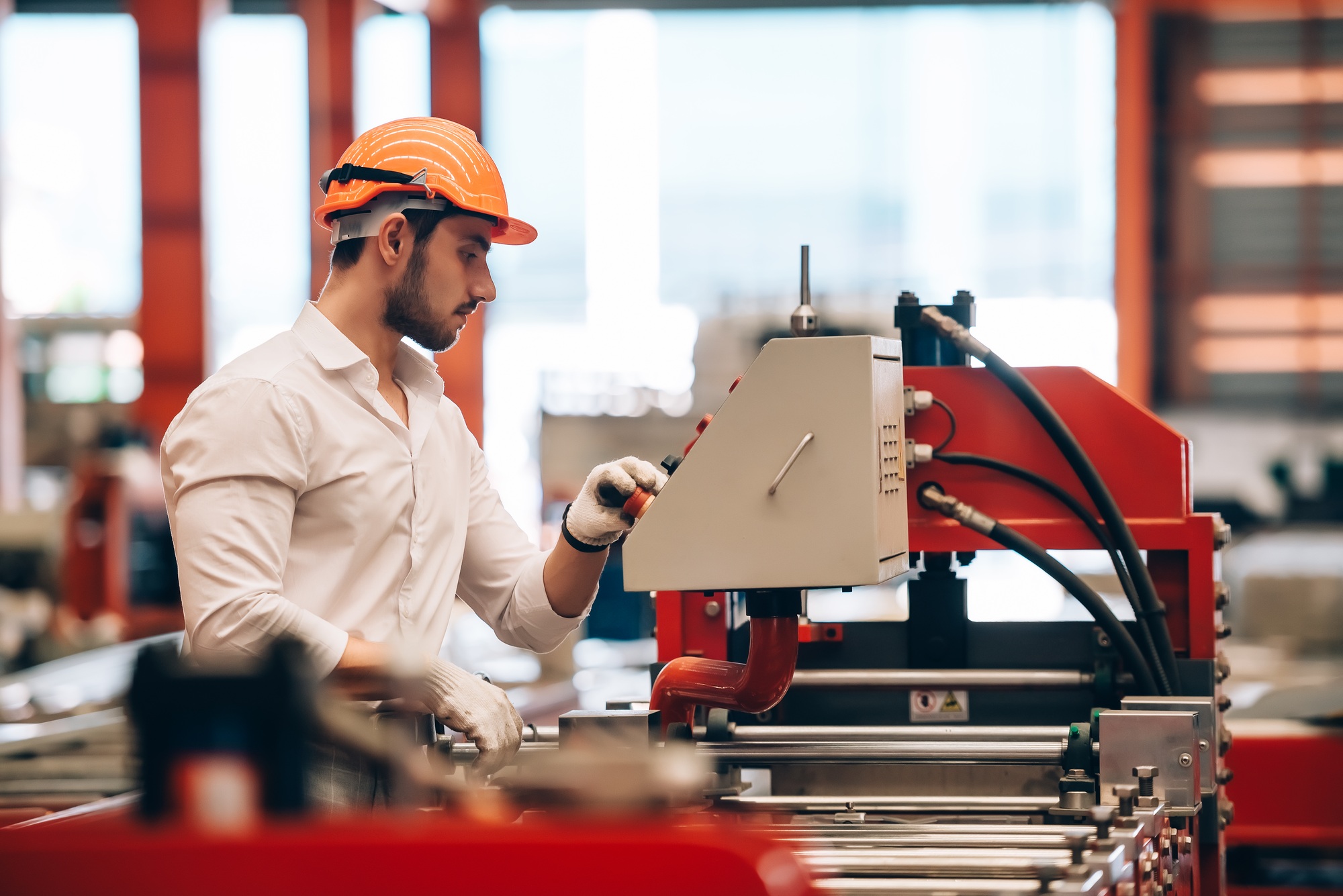 Industrial Efficiency: Factory Worker Monitoring Electrical Machine Process at Worksite