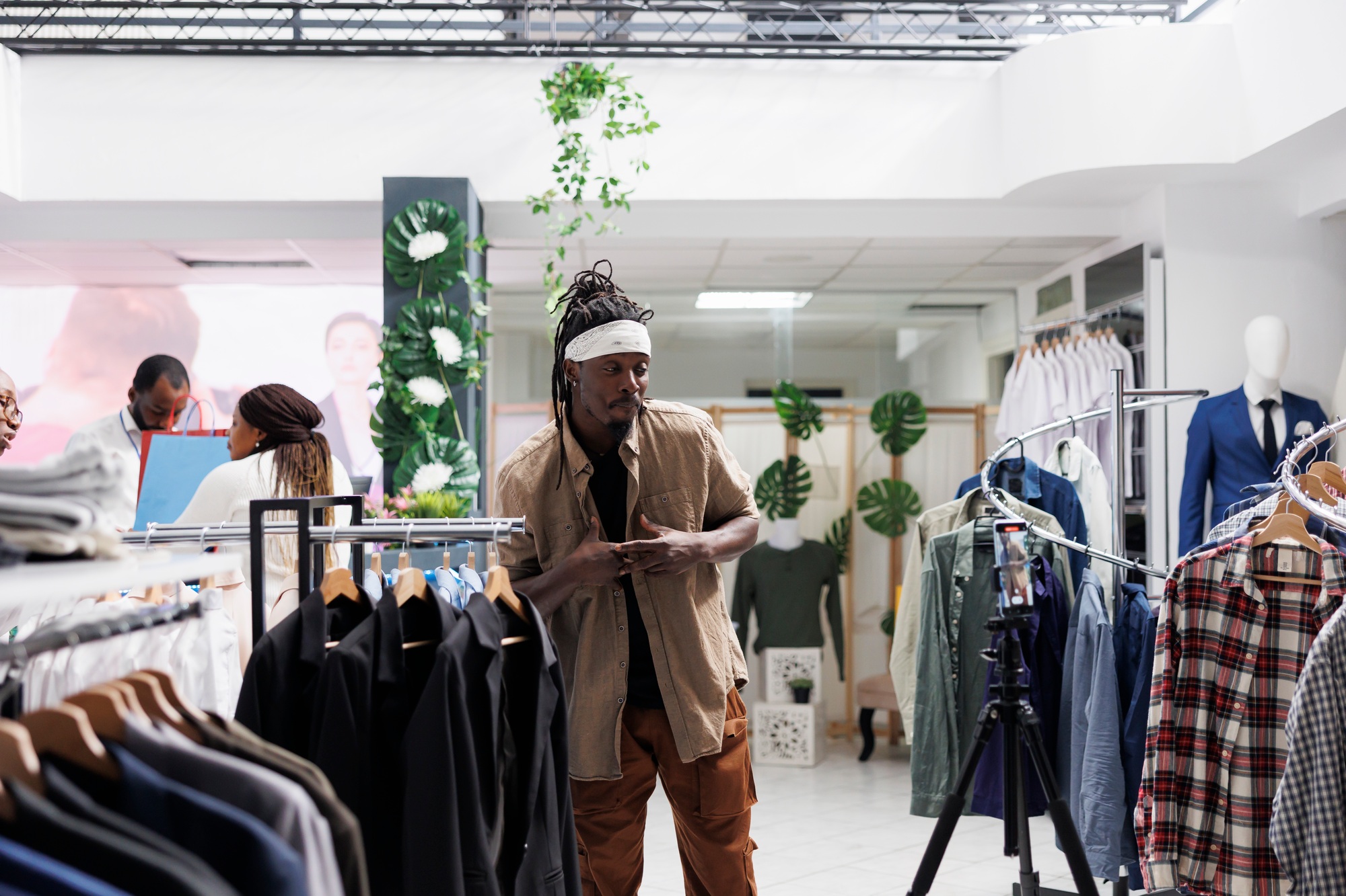 Influencer recording promotional video for clothing brand using smartphone