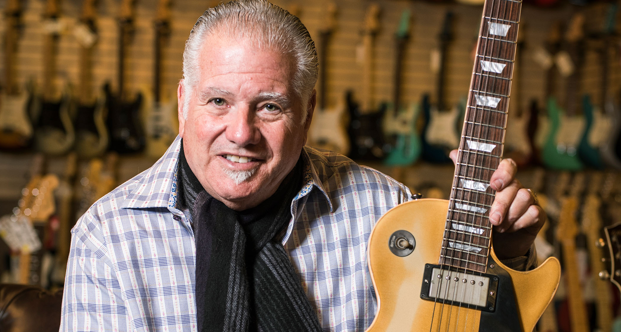 Norman Harris of Norman's Rare Guitars poses with a Les Paul at his legendary Tarzana, California guitar store