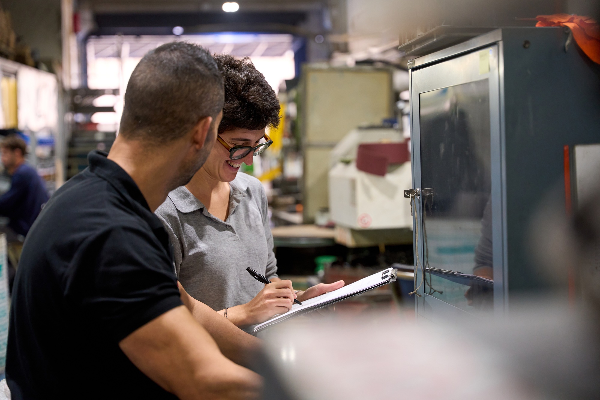 Metallurgy workers optimizing production process in steel mill