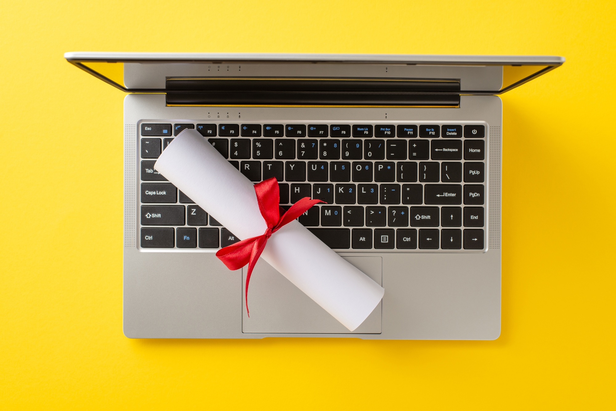 Online education milestone theme. Top view of laptop