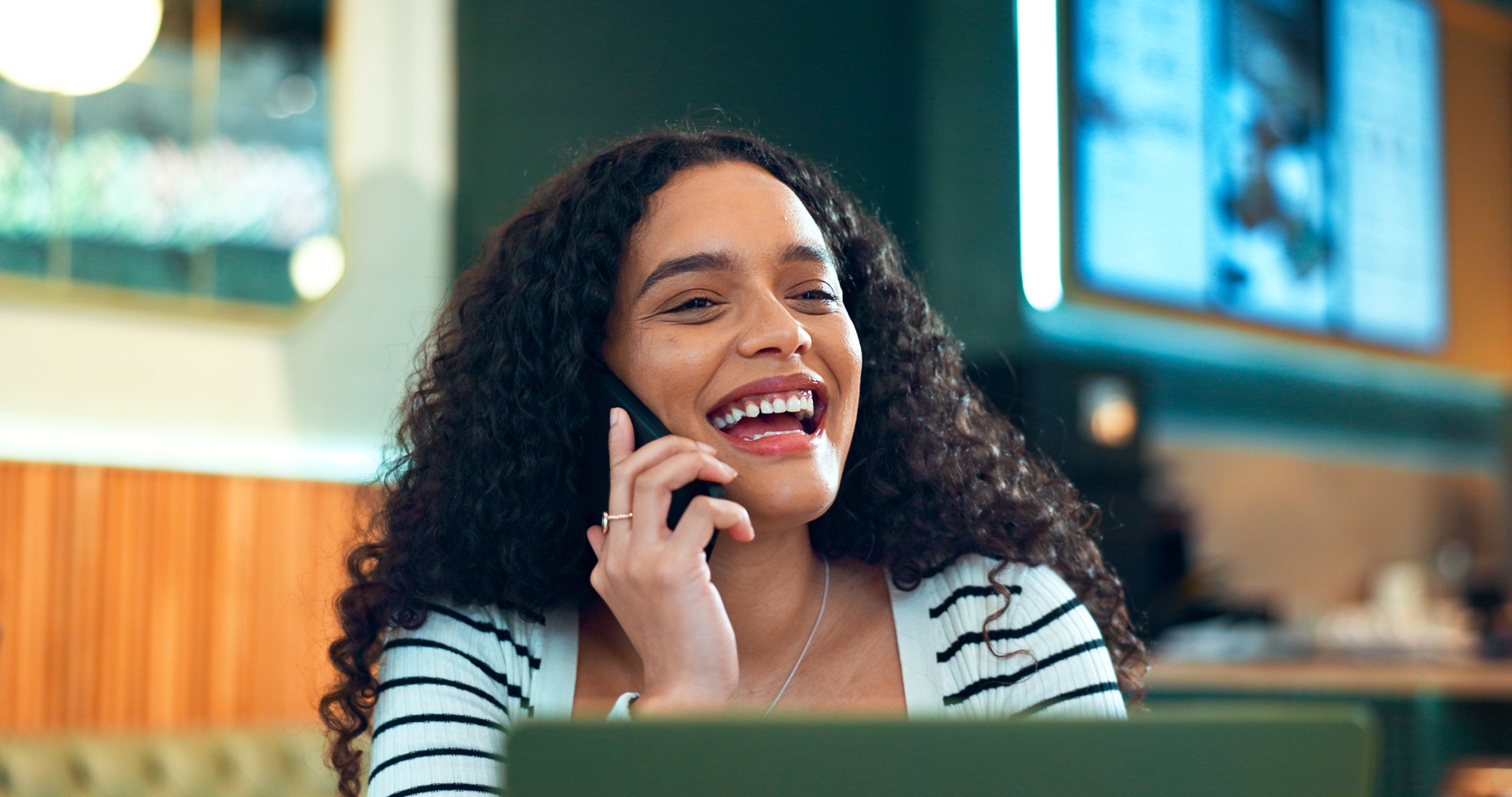 Woman, phone call and happy in cafe for remote work, communication or networking for business with