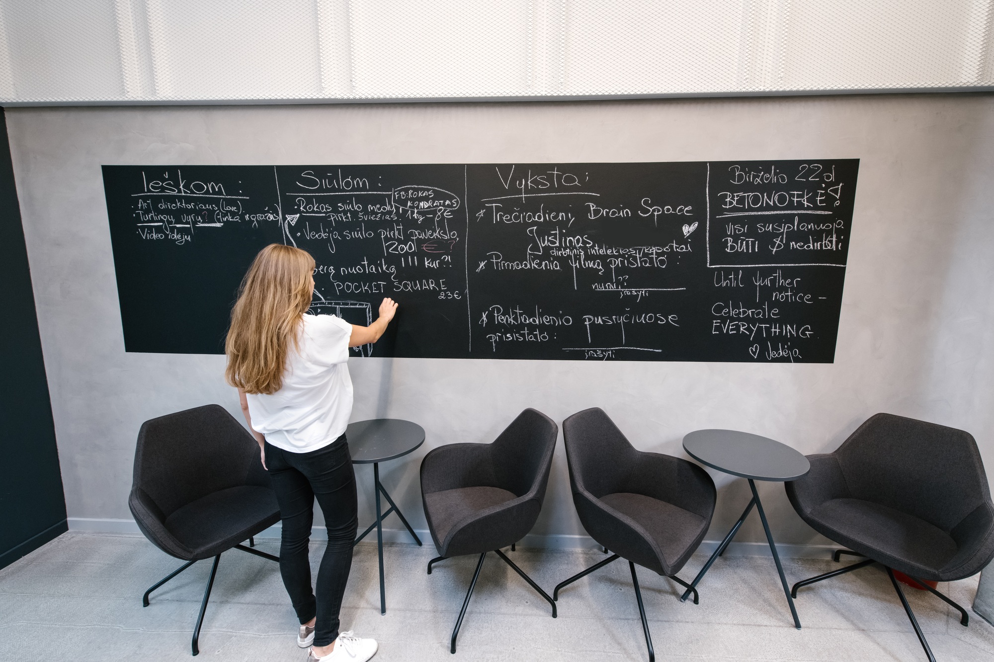 Woman writing on board in office