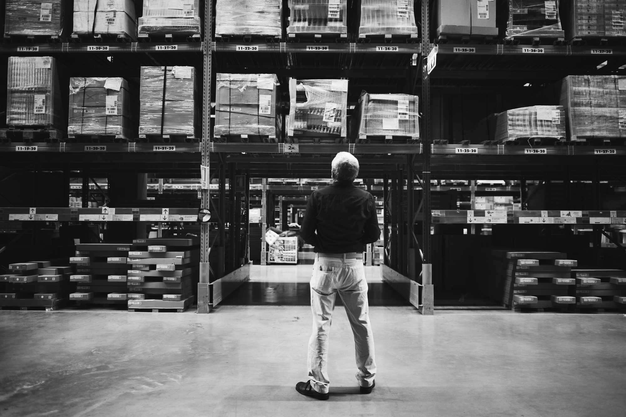 A Caucasian man is checking stock inventory