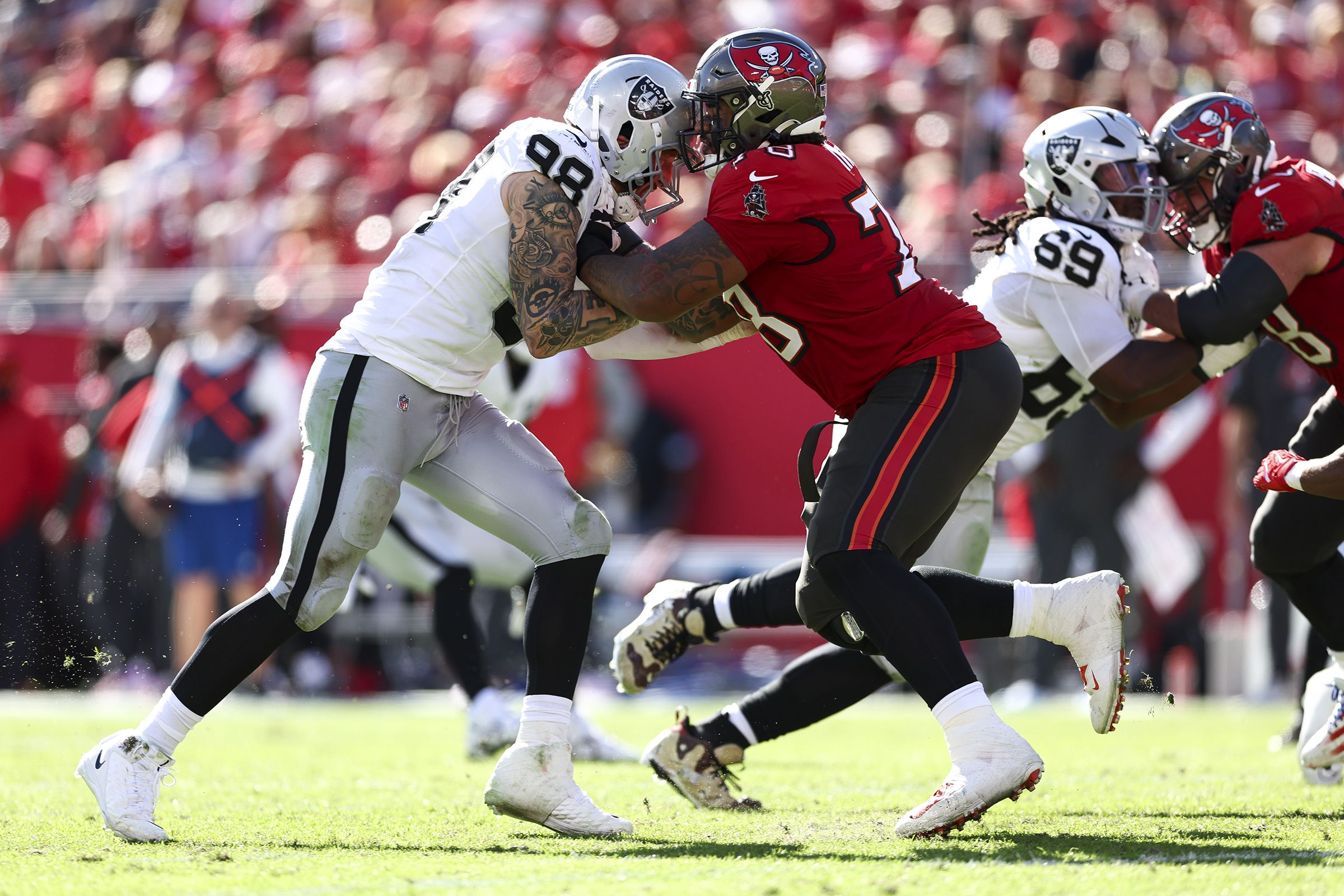 tampa, florida december 8: tristan wirfs #78 of the tampa bay buccaneers blocks maxx crosby #98 of the las vegas raiders during an nfl football game at raymond james stadium on december 8, 2024 in tampa, florida. (photo by kevin sabitus/getty images)