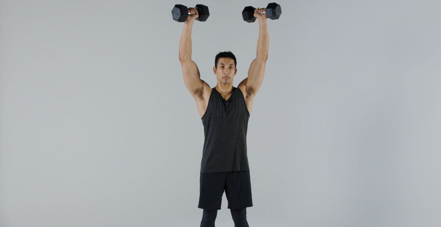 young man lifting weights in the gym