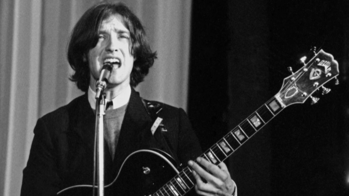 Dave Davies performs onstage with the Kinks