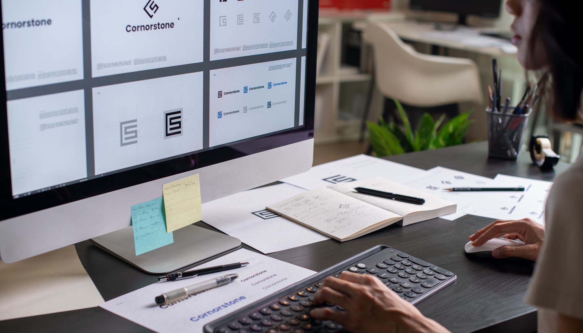 Graphic designer drawing sketches logo design.