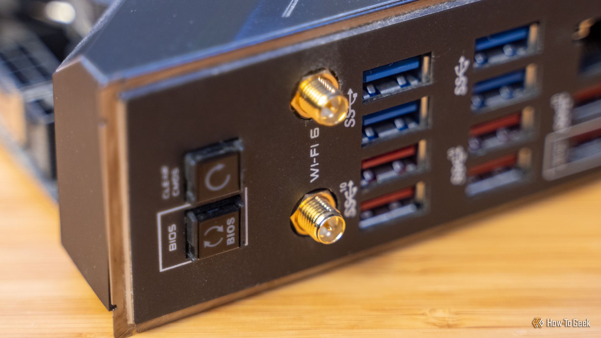 The back panel I/O of a motherboard showing USB ports and Wi-Fi antenna connectors,.