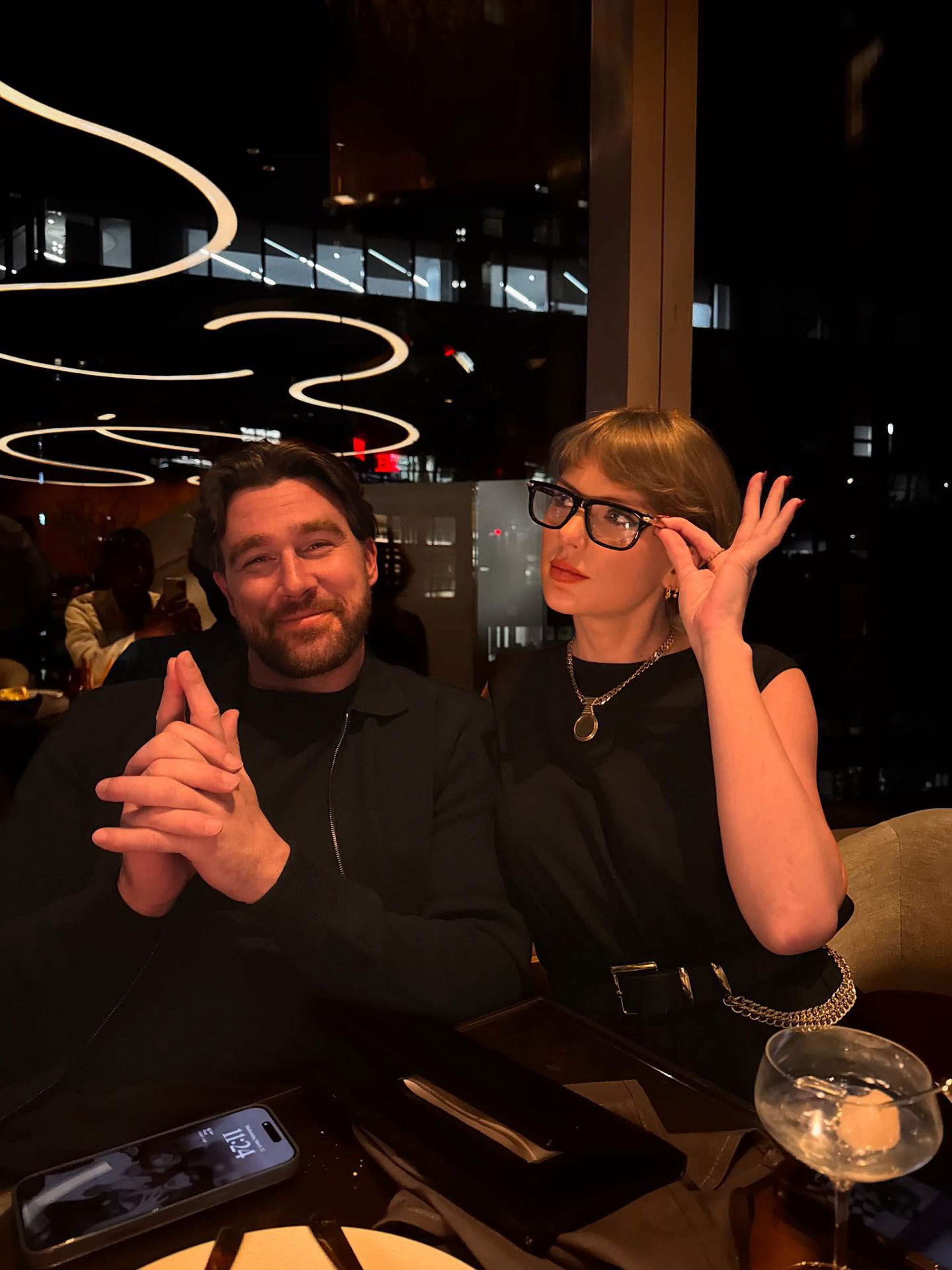 Taylor Swift and Travis Kelce posing for a photo.