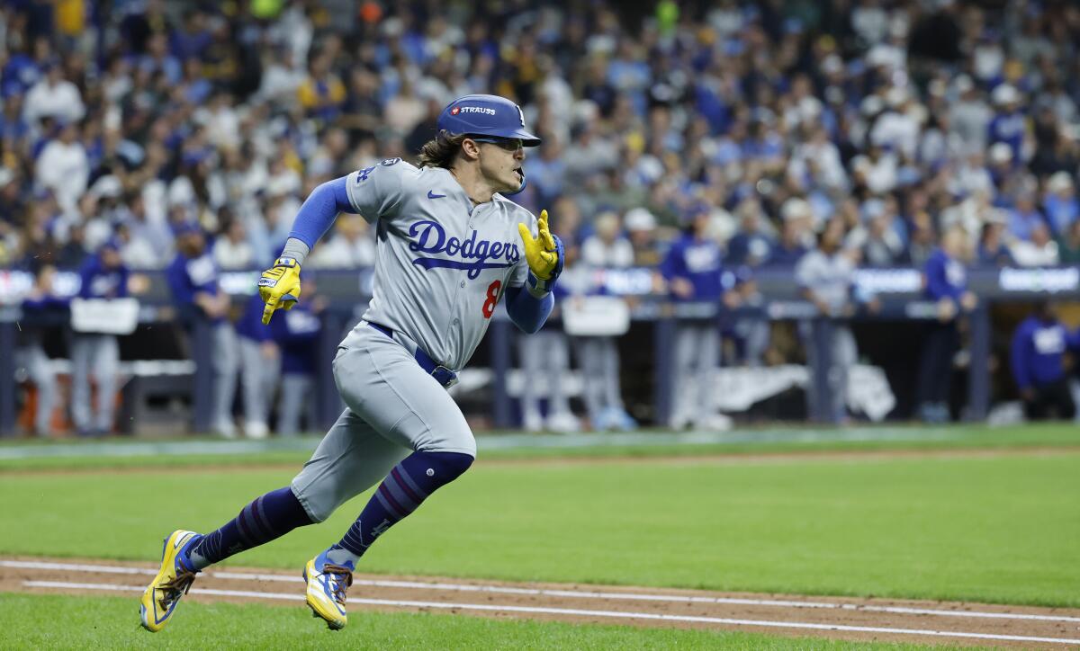 Kiké Hernández runs to first after hitting a standup double to lead off the seventh inning for the Dodgers.