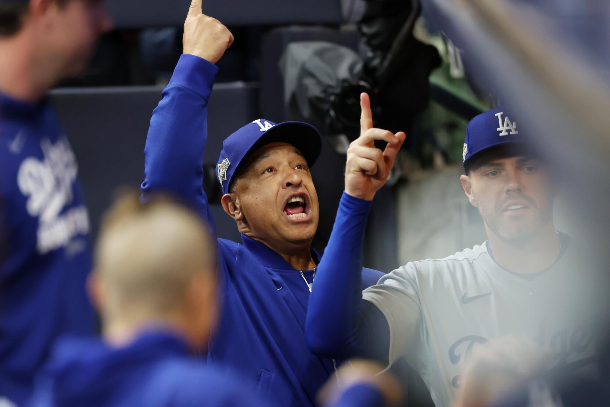Dodgers manager Dave Roberts and first baseman Freddie Freeman gesture.